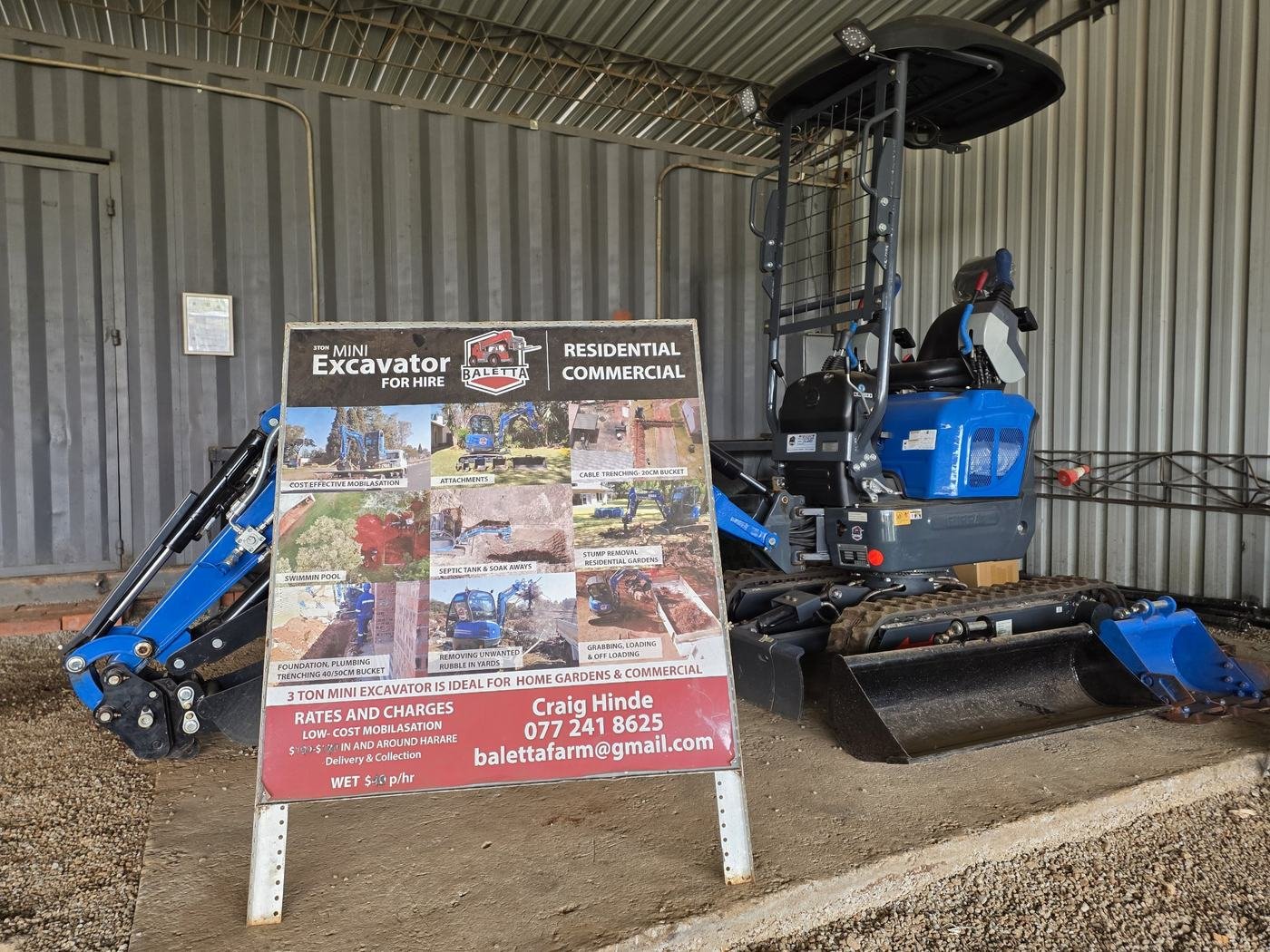 Rippa mini excavator beside the Baletta hire board