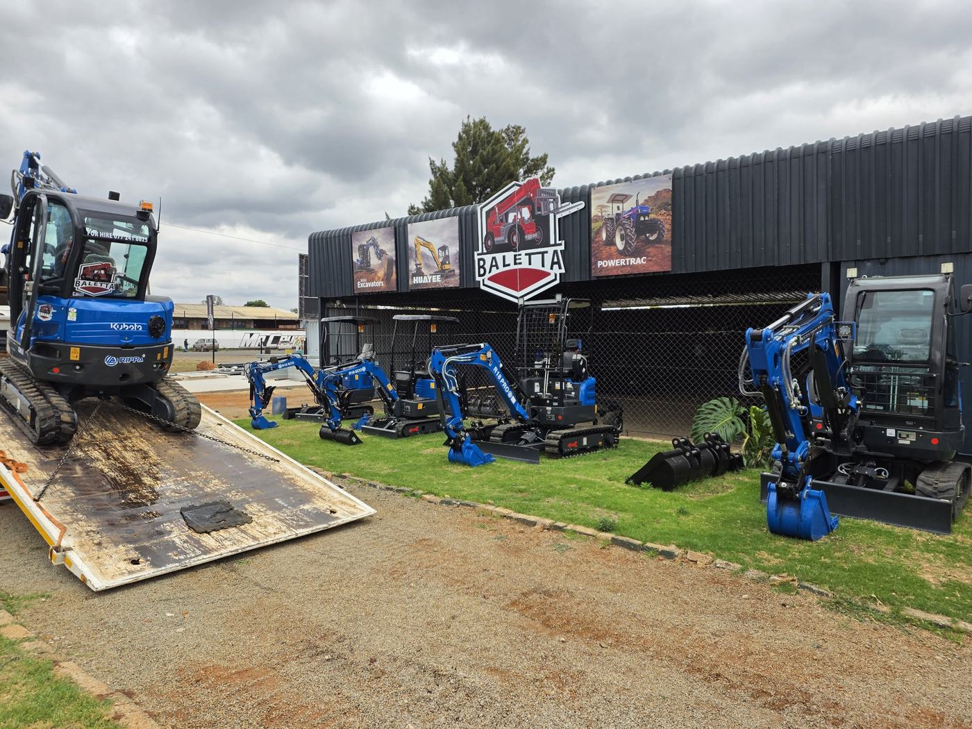 Baletta Rippa mini excavators lined up with a machine loading onto a low bed