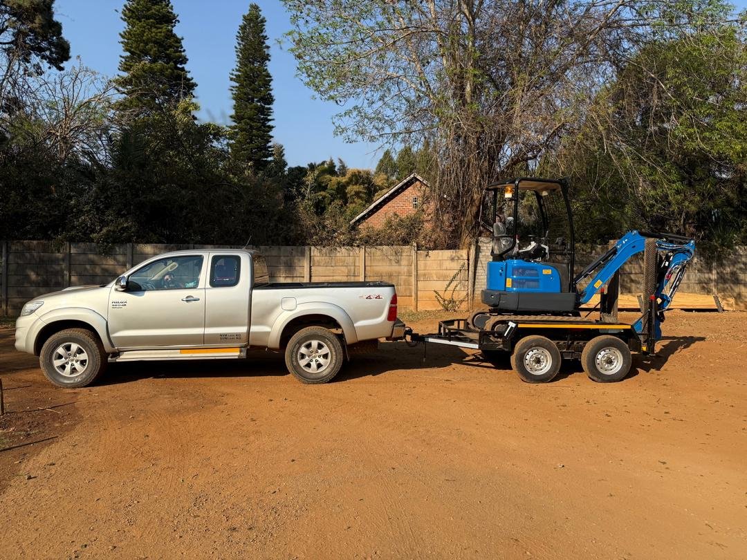 Rippa mini excavator delivered to site on a trailer behind the Baletta bakkie