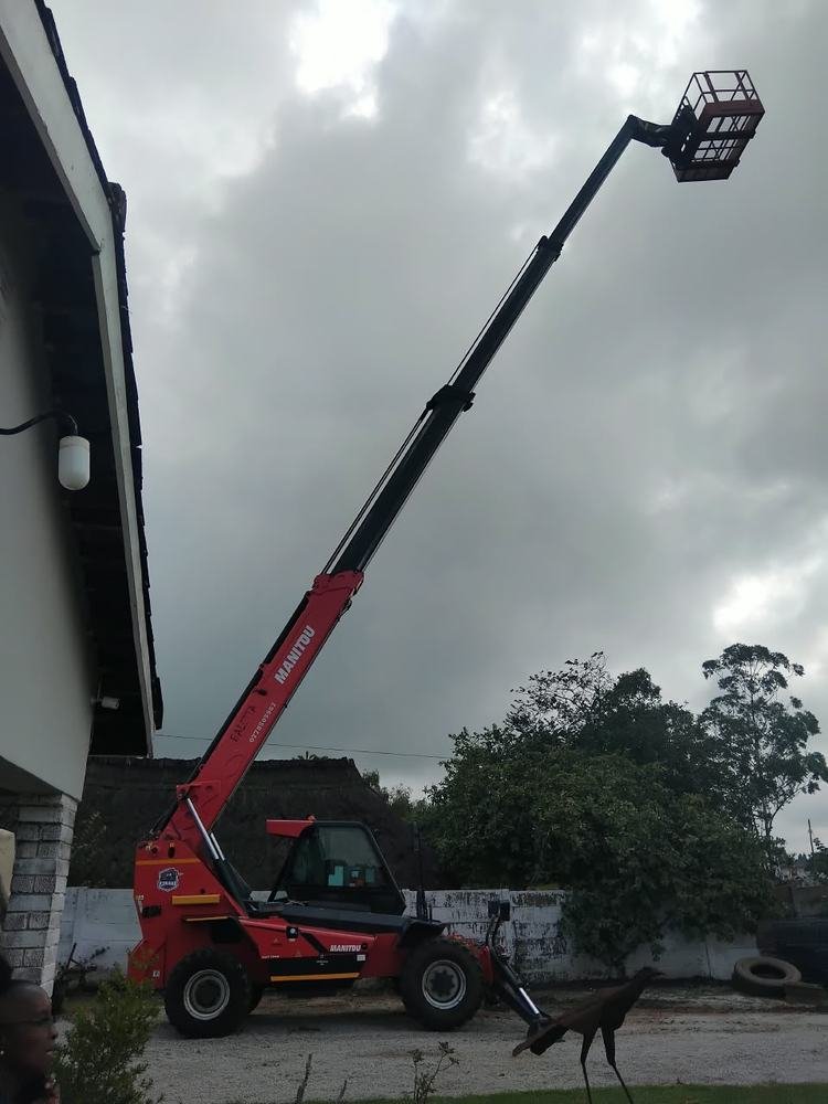 The Baletta telehandler at work beside a residential roof